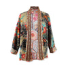 Colourful patterned quilted jacket on a white background