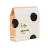 Oir hand and body soap packaging with black dots on a white background