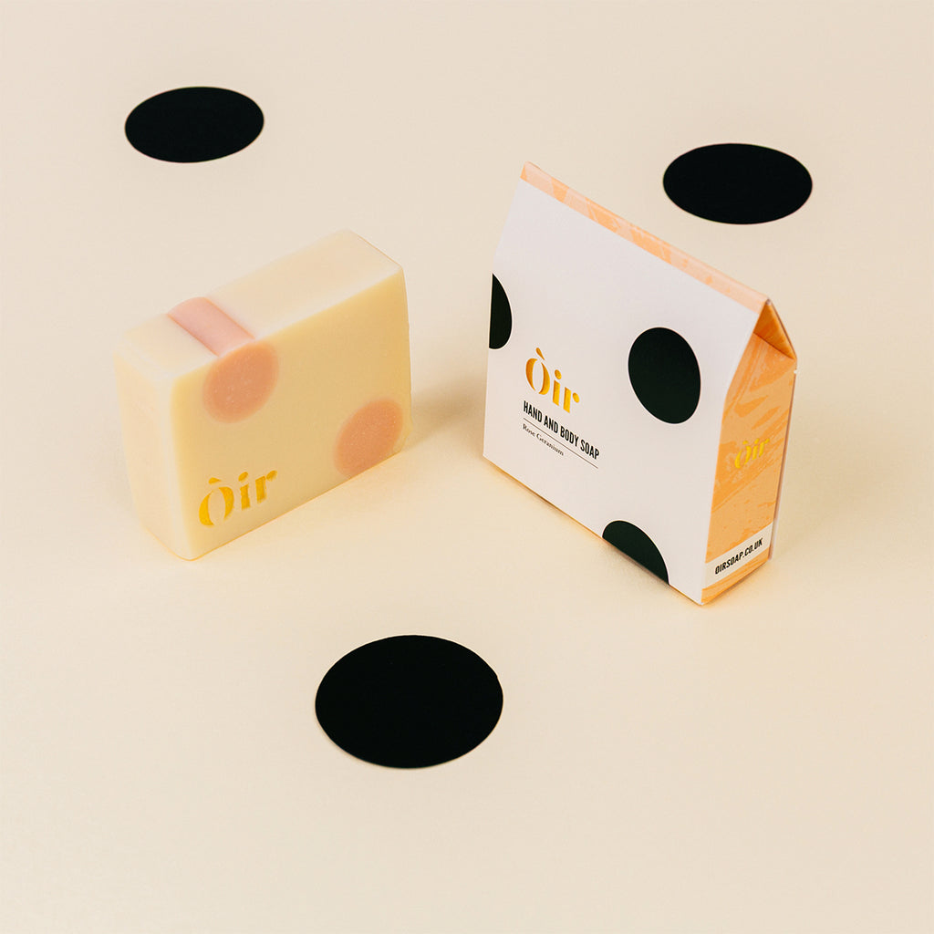 Bar of soap and packaging with 'Oir' branding on a beige background