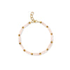 Bracelet with pink beads and gold accents on a white background