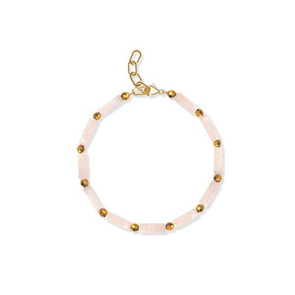 Bracelet with pink beads and gold accents on a white background