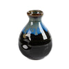 Black ceramic lipped vase with blue and brown accents on a white background