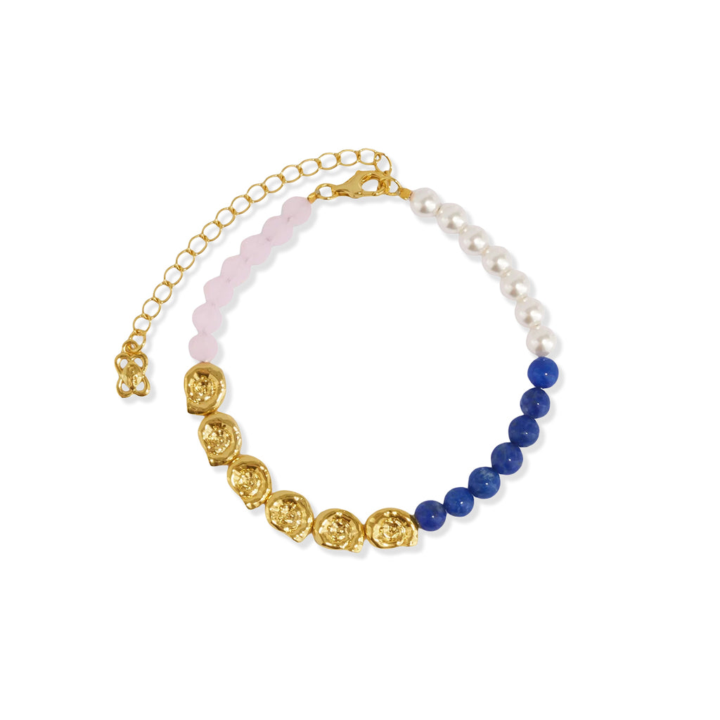 Gold tone bead bracelet with lapis lazuli, pink jade, faux pearl and golden shell beads on a white background.