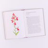Open book with a red flower illustration on a white background