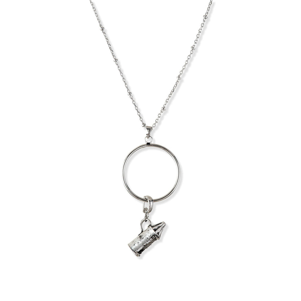 Silver necklace with a round pendant and smaller charm on a white background