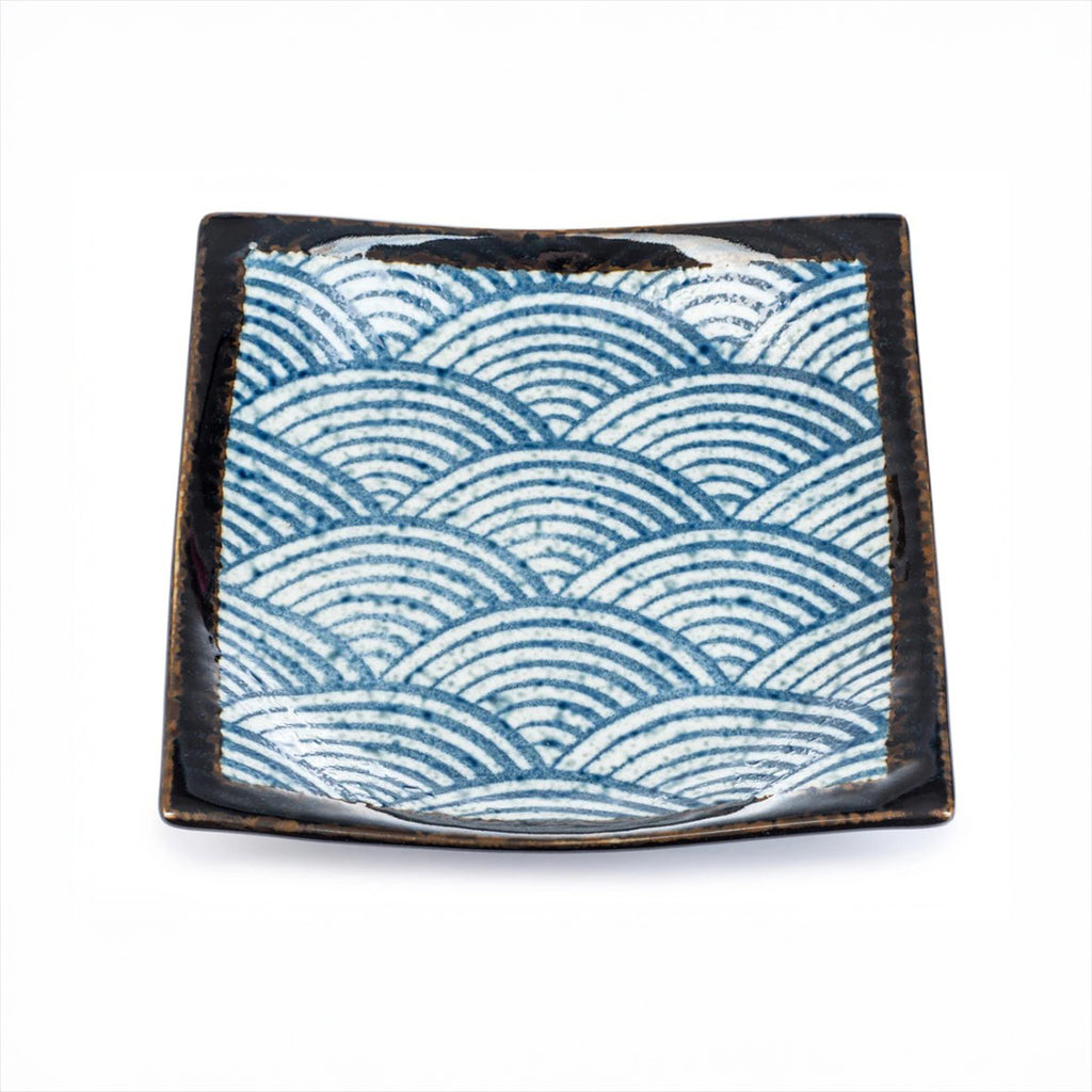Square ceramic dish with wave pattern on a white background