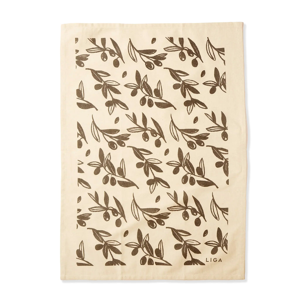 A cream-colored cotton tea towel featuring a repeating dark brown olive branch pattern and the brand name 'LIGA' printed in the bottom right corner, shown flat against a white background.