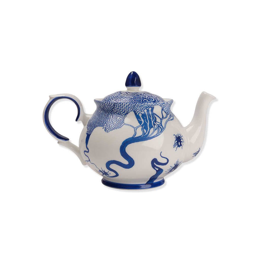 White teapot with blue sketch design on a white background