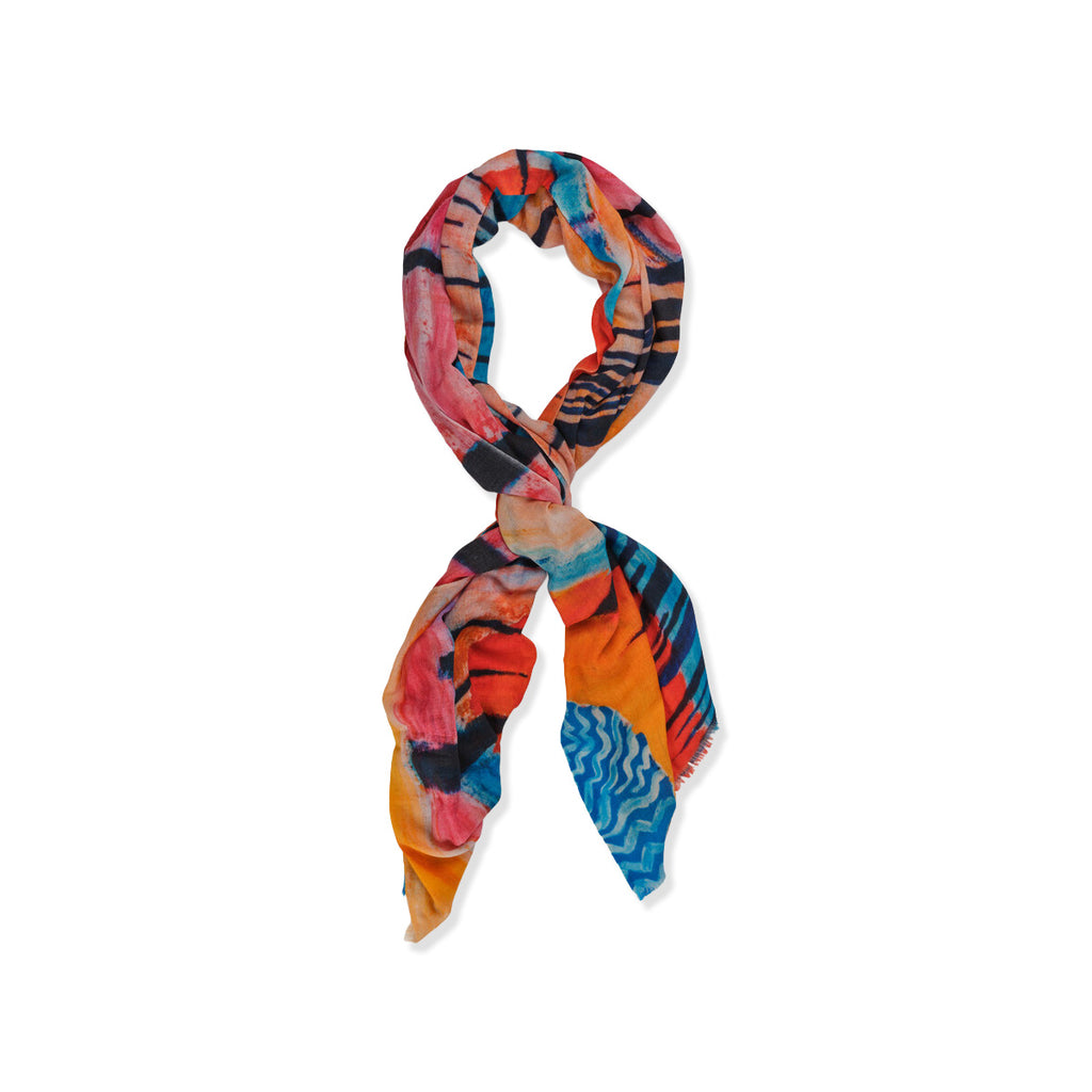 Colourful patterned wool and silk blend scarf on a white background