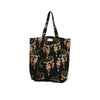 A black canvas tote bag with a wisteria floral print in shades of beige and olive green, featuring dual shoulder straps and a small white brand label at the top center.