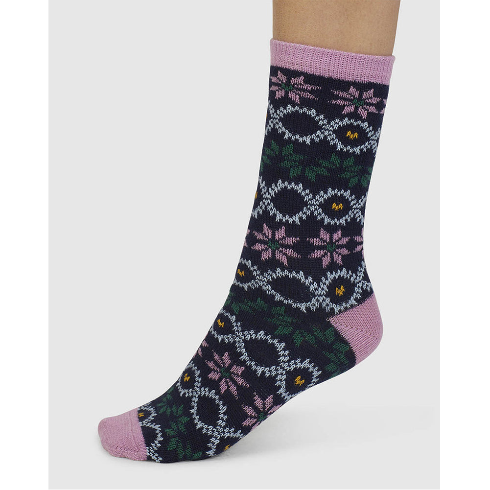 Sock with a floral fair isle pattern on a white background