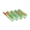 Green multicolour plastic soap dish in zig zag design on a white background