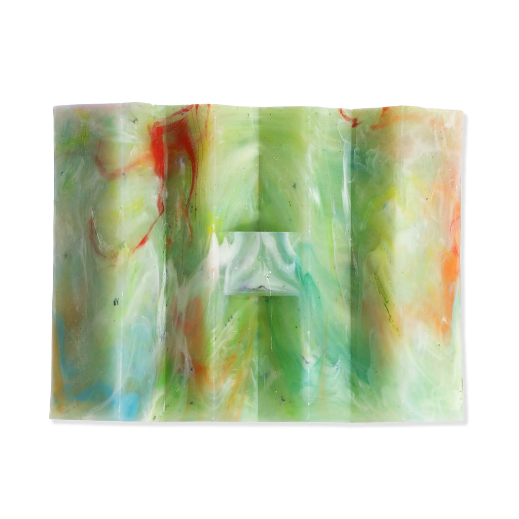 Colourful swirled soap dish on a white background
