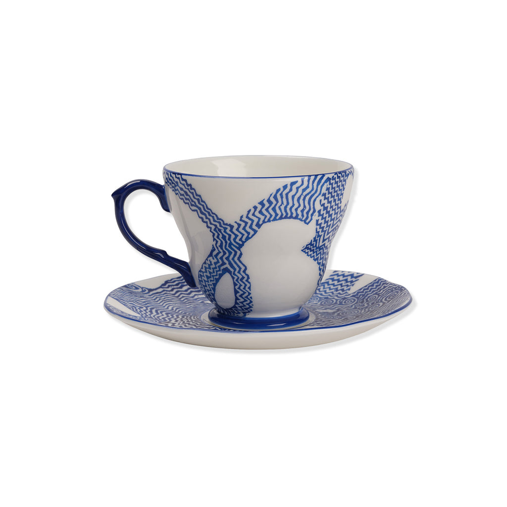 Ceramic cup and saucer with blue and white pattern on a white background