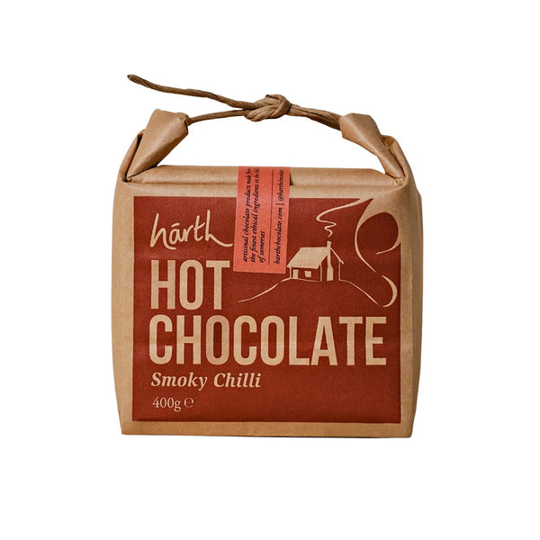 A square kraft paper package of Harth Hot Chocolate Smoky Chilli, featuring a brown and beige label with a small red-orange accent strip, set against a plain white background.