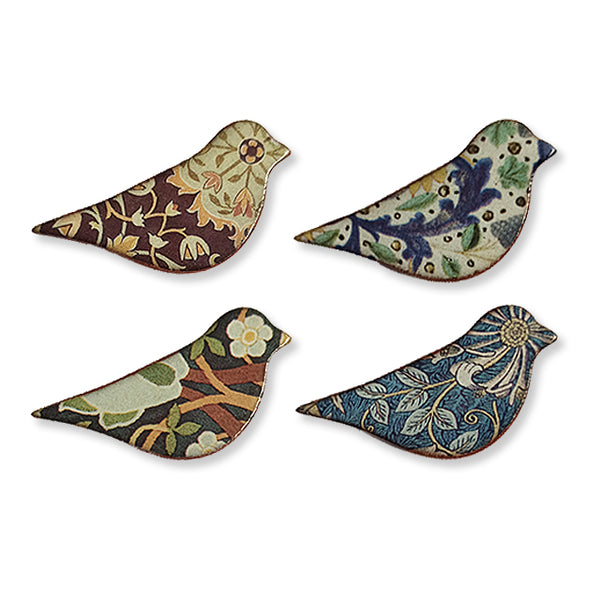 A set of four ceramic bird brooches with various patterns and colors.